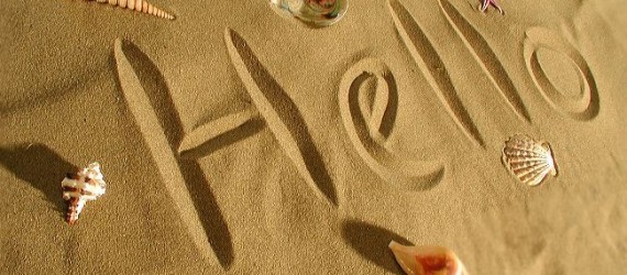 Hello written on a sandy beach