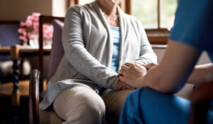Elderly woman with nursing home worker