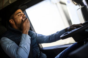 man with sleep disorder, yawning and driving
