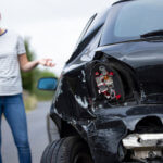 Woman on the phone after a car accident